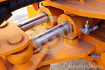 Powerful hydraulic pumps that stand in the bucket of an excavator, industry, close-up, orange Stock Photo