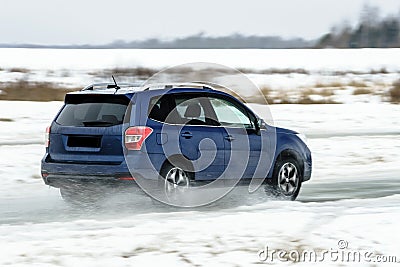 Powerful offroader car sliding by lake ice Stock Photo