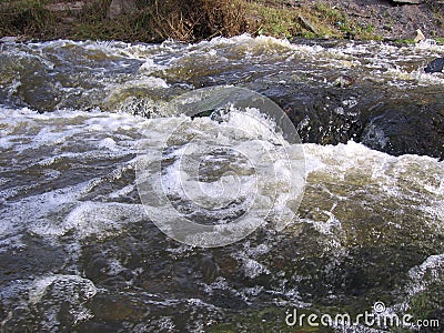 A powerful, raging torrent of water in the river the spring flood foam on the waves Stock Photo