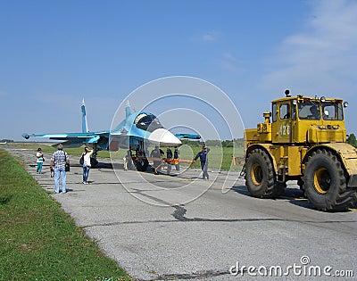 Powerful Russian military jet fighter plane on the runway of the SU-34 tractor carries engine Editorial Stock Photo