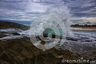 Powerful splash against rock formations Stock Photo