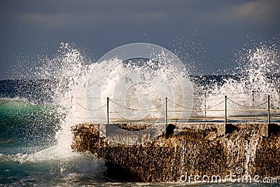 Powerful Stunning Wave Crashing Against Outdoor Pool. Stock Photo