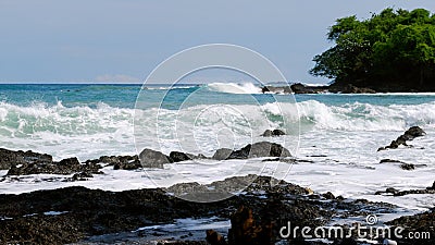 Powerful waves strike volcanic rock at Montezuma Beach Stock Photo