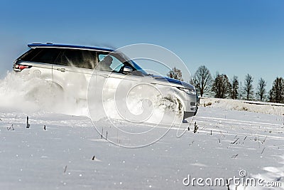 Powerful 4x4 offroader car running on snow field Stock Photo