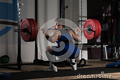 Powerlifter Doing Exercise For Legs With Barbell Stock Photo