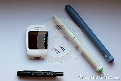 Poznan, Poland - 10.20.2022: Accu-Chek Instant glucose meter with toujeo long insulin and apidra short insulin Editorial Stock Photo