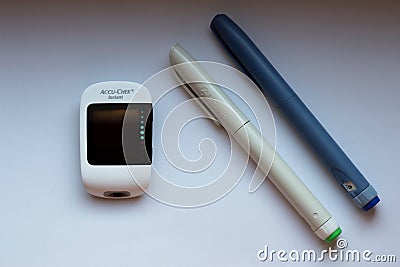 Poznan, Poland - 10.20.2022: Accu-Chek Instant glucose meter with toujeo long insulin and apidra short insulin Editorial Stock Photo