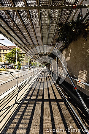 A view full of play of light and shadow in the passage tunnel under the scaffolding at the renovated Editorial Stock Photo