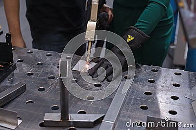 Cutting steel, plasma. A woman cuts steel Editorial Stock Photo