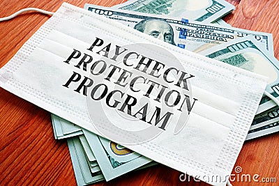 PPP Paycheck Protection Program as SBA loan written on the mask. Stock Photo