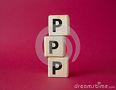 PPP private public partnership symbol. Wooden cubes with words PPP. Beautiful red background. Business and PPP concept. Copy space Stock Photo