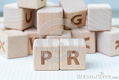 PR, Public Relations concept, wooden cube block with letters for Stock Photo