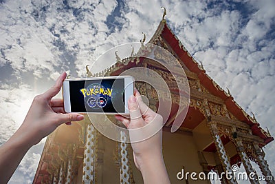 Prachuapkhirikhan,Thailand - August 6,2016 : woman hand holding smart phone to play Pokemon Go Editorial Stock Photo