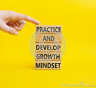 Practice and Develop growth mindset symbol. Wooden blocks with words Practice and Develop growth mindset. Beautiful yellow Stock Photo