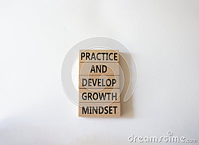 Practice and Develop growth mindset symbol. Wooden blocks with words Practice and Develop growth mindset. Beautiful white Stock Photo