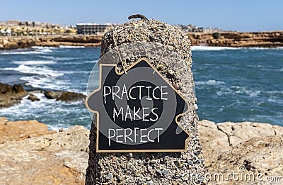 Practice makes perfect symbol. Concept words Practice makes perfect on beautiful black chalk blackboard. Beautiful stone sea sky Stock Photo