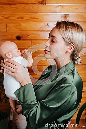 Practice of motherhood, parenthood concept. Young caucasian woman holding realistic newborn baby reborn doll in arms Stock Photo