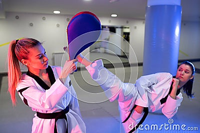 Practicing taekwondo with durable kick pad targets Stock Photo