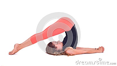 Practicing Yoga exercises / Plow Pose - Halasana Stock Photo