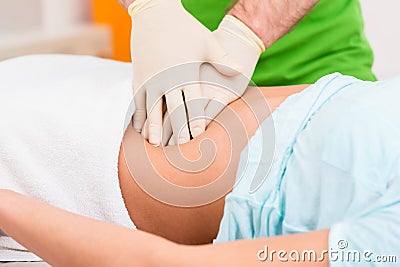 Practitioner at colon therapy massaging abdomen Stock Photo