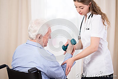 Practitioner showing patient exercise Stock Photo