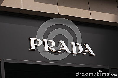 Prada logo on front store in shopping street. Prada is a world famous fashion brand founded in Italy. Editorial Stock Photo