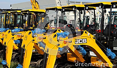 JCB logos on the mini excavators boom outside the official dealer. Editorial Stock Photo