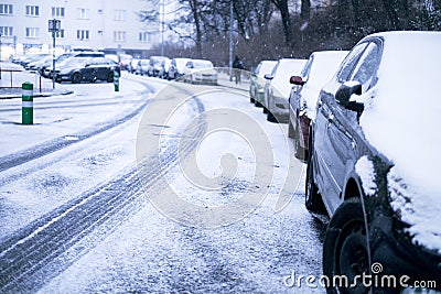 Prague city street under the snow. Cars driving on a blizzard road. Snow calamity in the city. Snow covered cars. Winter Stock Photo