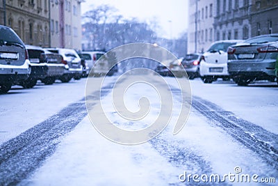 Prague city street under the snow. Cars driving on a blizzard road. Snow calamity in the city. Snow covered cars. Winter Stock Photo