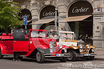 PRAGUE, CZECH REPUBLIC - APRIL 21, 2017: Two vintage Ford cars parked in front of a Cartier shop in the Parizska street Editorial Stock Photo