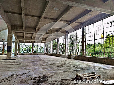 Old abandoned and ruined factory building interior with broken windows, but clean floors Editorial Stock Photo