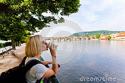 Prague, Czech Republic. Female traveler drinking coffee and enjoying a panoramic view. Stock Photo