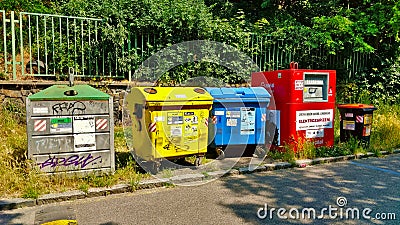 Colored trash cans for recyclable waster standing by the road Editorial Stock Photo