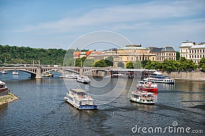 Prague, Czech Republic - June 03, 2017: pleasure boats on Vltava river. Holiday cruiser ships on cityscape on blue sky. Summer vac Editorial Stock Photo