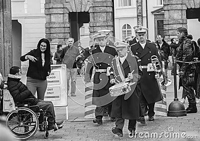 Prague, Czech Republic - March 13, 2017: Military musicians are passing by tourists Black and white image Editorial Stock Photo