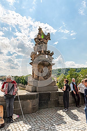 Sculpture of Saint Ludmila with little Vaclav by Mathias Bernard Brown on the Charles Bridge in Prague in Czech Republic Editorial Stock Photo