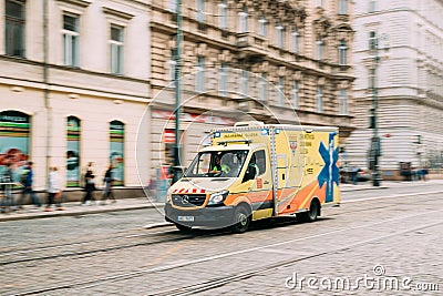 Prague, Czech Republic. Moving With Siren Bright Yellow Emergency Ambulance Reanimation Mercedes Benz Van Car Editorial Stock Photo