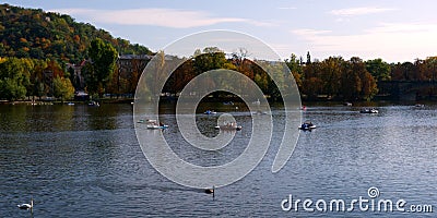 Tourists in small boats ride along the Vltava in the autumn. Rest on the river. Autumn Editorial Stock Photo