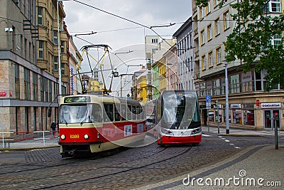 Prague, Czech Republic; 5/17/2019: Red old tram circulating beside an red new one Editorial Stock Photo