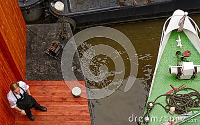 Prague, Czech republic: Riverside cigarrete break. Editorial Stock Photo