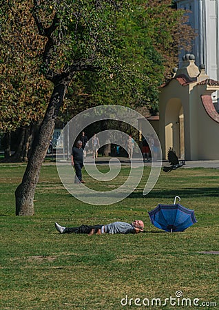 Prague, Czech Republic - September 10, 2019: bold Man sleeps on the grass in a sunny day at kampa park Editorial Stock Photo