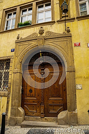 PRAGUE, CZECH REPUBLIC: Unusual miniatures decor on wooden door. Beautiful door Editorial Stock Photo