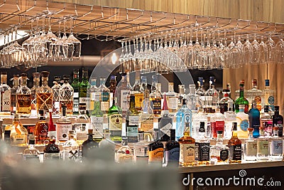 Prague - December. 12, 2023: Bottles of whiskey rum and other spirits in the restaurant bar. A large assortment of alcoholic Editorial Stock Photo