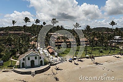 Church with coconut trees in the background and tourists in front of it on the beach Editorial Stock Photo