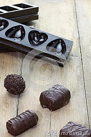 Pralines with chocolate molds on the background Stock Photo