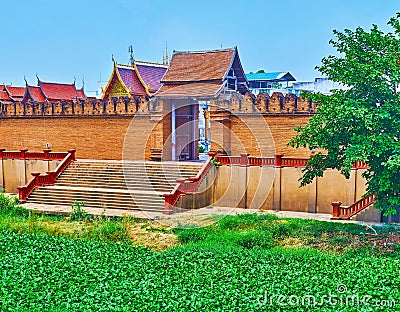 Pratu Thanang Gate with water hyacinth on Kuang River in foreground, Lamphun, Thailand Stock Photo