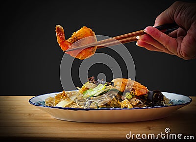 Prawn in chopstick, asia glass noodles with vegetables Stock Photo