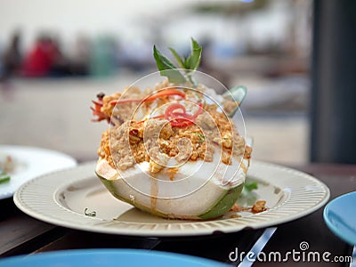 Prawns, clams, crabs, fish steamed spicy Thai with curry paste, served in coconut milk, Homok with coconut meat and seafood, put o Stock Photo