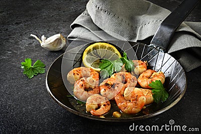 Prawns shrimps with garlic, lemon, spices and italian parsley ga Stock Photo