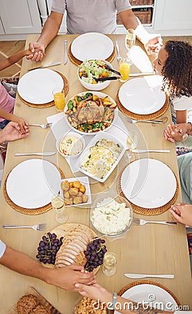 Pray, food and family friends dinner at a table with gratitude, love and religion faith before eating. Praying at a meal Stock Photo